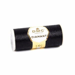 May include: A spool of black DMC Diamant thread. The spool is labeled with the DMC logo and the text "Diamant".