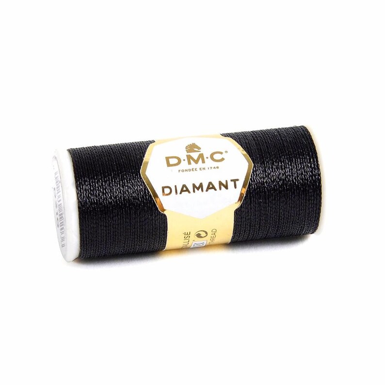 May include: A spool of black DMC Diamant thread. The spool is labeled with the DMC logo and the text "Diamant".