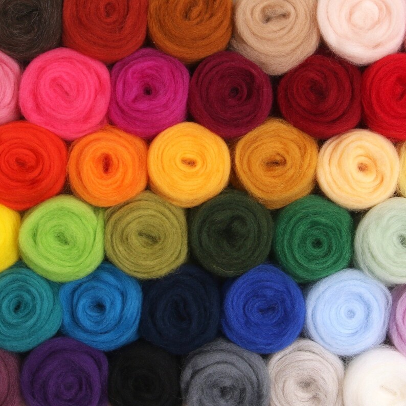 May include: A collection of colorful yarn balls in various shades of blue, green, red, orange, yellow, purple, and brown. The yarn balls are arranged in a circular pattern.