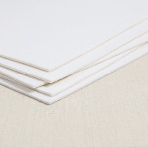 May include: A stack of white felt sheets, perfect for crafting projects.