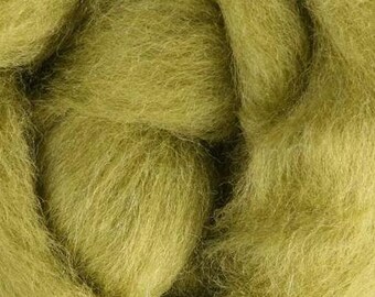 May include: Close-up of a mass of olive green wool roving. The fibers are soft and fluffy, with a slightly textured appearance. The wool is tightly packed, creating a dense, cloud-like form. Ideal for fiber art projects.