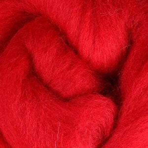 May include: A close-up of a bright red wool roving. The roving is soft and fluffy, perfect for felting or spinning.