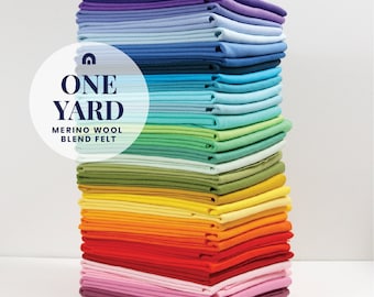 May include: A stack of 20 different colored felt squares, each measuring one yard. The felt is a merino wool blend. The text "ONE YARD MERINO WOOL BLEND FELT" is on a white circle with a blue border.