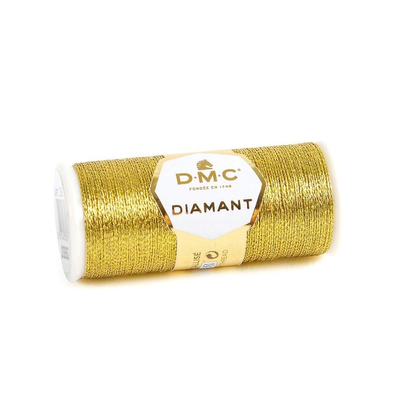 May include: A spool of gold metallic thread with the DMC Diamant label. The label features a horse head logo and the text "DMC Fond&eacute;e en 1746 Diamant".