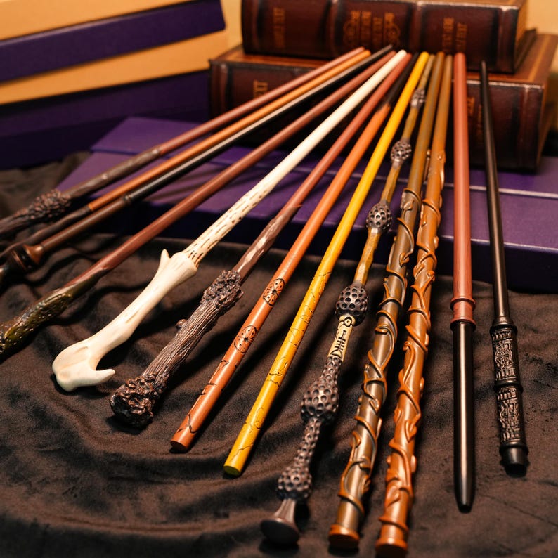 May include: A collection of wizard wands in various colors and designs. The wands are made of wood and other materials, with intricate carvings and details. Some wands have a smooth finish, while others have a textured appearance. The wands are arranged on a dark surface.