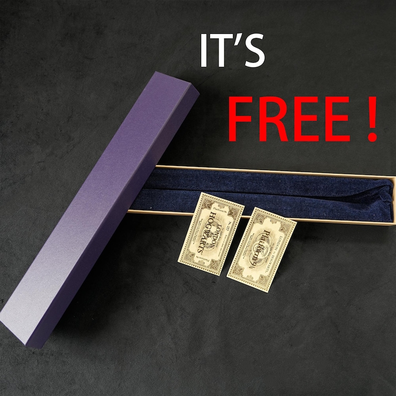 May include: A purple rectangular box with a matching wand inside, along with two small tags. The box is open, revealing a dark blue interior. The text "IT'S FREE!" is displayed in white and red.