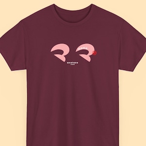 May include: Burgundy t-shirt with a pink graphic of the word "mama" in Japanese characters. The graphic also includes a small red flower. The text "anatano JAPAN" is printed below the graphic.