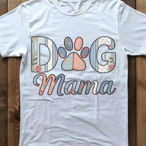 May include: A white ceramic mug with a black handle and the text "But First, Coffee" in a black, handwritten-style font. The mug is on a white surface.