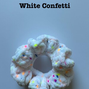 May include: White scrunchie with colorful confetti sprinkles.