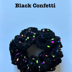 May include: Black velvet scrunchie with colorful confetti print.