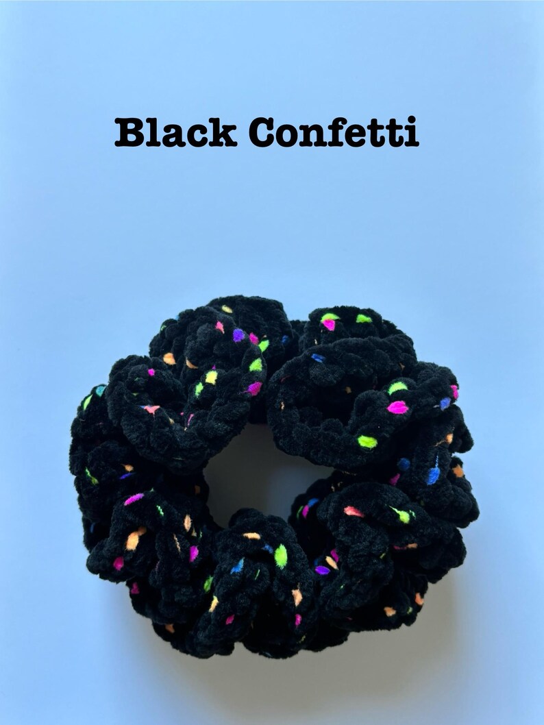 May include: Black velvet scrunchie with colorful confetti print.