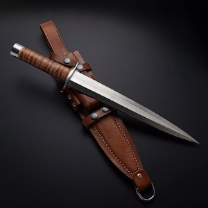 May include: A dagger with a polished steel blade and a brown leather-wrapped handle. The dagger is sheathed in a brown leather scabbard with a belt loop and snap closures. The blade is approximately 10 inches long.
