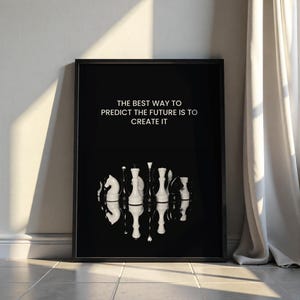May include: Black and white framed print with a quote about creating the future. The quote reads "The best way to predict the future is to create it". The print features a black background with white chess pieces reflected in a mirror-like surface.