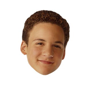 May include: A close-up portrait of a young man with short, brown, curly hair. He is smiling and looking directly at the camera.