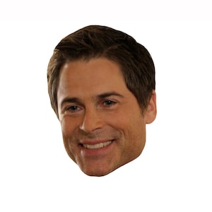 May include: A close-up of a man's face. He has short brown hair and is smiling.