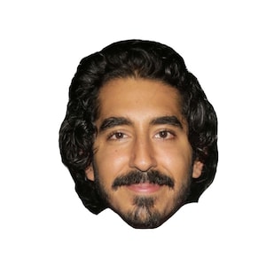 May include: A close-up portrait of a man with dark brown hair and a beard. He is smiling and looking directly at the camera.