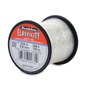 May include: A spool of clear elastic cord, labeled "Beadalon Elasticity Elastic Cord Cordon Elastique Cordón Elástico". The spool is 328 feet (100 meters) long and 0.032 inches (0.8 mm) in diameter.