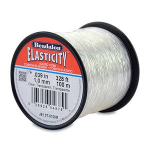 May include: A spool of clear elastic cord, Beadalon Elasticity, 1.0 mm thick, 328 feet long, or 100 meters long. The label reads "Elastic Cord, Cordon Elastique, Cordón Elástico".