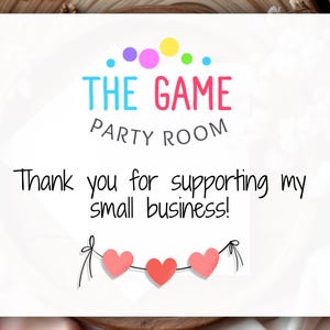 May include: White card with the text "THE GAME PARTY ROOM" in colorful letters. Below, it reads "Thank you for supporting my small business!" A string of three pink hearts hangs at the bottom.