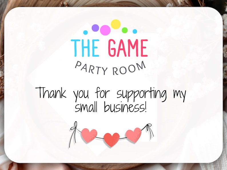 May include: White card with the text "THE GAME PARTY ROOM" in colorful letters. Below, it reads "Thank you for supporting my small business!" A string of three pink hearts hangs at the bottom.