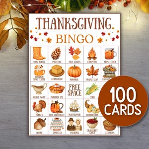 May include: Thanksgiving Bingo game card with colorful illustrations of fall-themed items like pumpkins, corn, and turkey. The card includes the text "Thanksgiving Bingo" and a circular graphic that says "100 Cards".