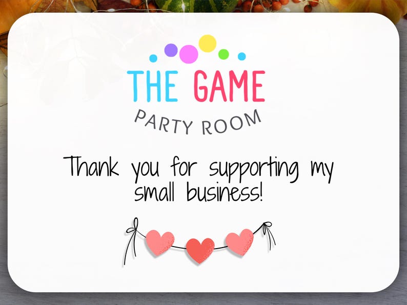 May include: A white card with the text "THE GAME PARTY ROOM" in colorful letters. Below, it reads "Thank you for supporting my small business!" Three pink hearts are strung across the bottom.