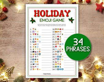 May include: A festive holiday emoji game sheet with the title "HOLIDAY EMOJI GAME" in red. The sheet features 34 phrases to guess, with a green circle that says "34 PHRASES". The game is set against a wooden background.