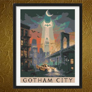 May include: A framed cross-stitch pattern depicting a cityscape at twilight with a yellow taxi in the foreground, a bridge on the right, and a bat signal in the sky. The text GOTHAM CITY is printed in black capital letters at the bottom of the image.