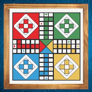 May include: A framed Ludo board game with a colorful design. The board features red, green, blue, and yellow squares, each with a white diamond in the center. The game board is framed in a wooden frame.
