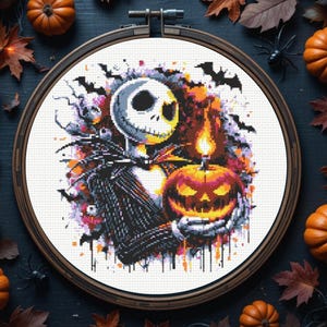 May include: Cross-stitch art in a wooden hoop featuring Jack Skellington holding a lit jack-o'-lantern. The design includes bats, a spooky background, and is surrounded by pumpkins and autumn leaves.
