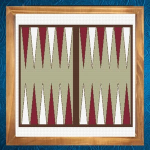 May include: A framed backgammon board with a wooden frame. The board features a symmetrical design with alternating red, white, and tan triangles. The background is a light tan color, and the frame is a warm brown.
