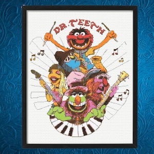 May include: Cross-stitch artwork of the Muppets' band, Dr. Teeth and The Electric Mayhem, in a black frame. The image features the band members playing instruments, with the band name at the top. The artwork is on a white background.