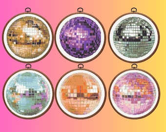 May include: Six circular embroidery hoops containing cross-stitch patterns of disco balls in gold, purple, silver, light blue, orange, and pink. Each hoop features a wooden frame with a metal tightening screw at the top, displaying pixelated mirror tiles.