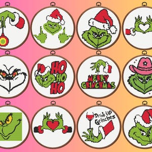 May include: A collection of twelve cross-stitch designs featuring the Grinch in various Christmas-themed scenes. Each design is set within a wooden embroidery hoop. The Grinch is depicted with a Santa hat, holding ornaments, and with the text "Merry Grinchmas".