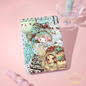 Può includere: Una custodia per telefono a tema menta e gocce di cioccolato, con personaggi dei cartoni animati, dessert e note musicali. La custodia ha uno sfondo azzurro con varie illustrazioni.