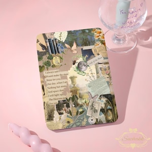 May include: A decorative tablet case featuring a collage design with butterflies, flowers, and vintage elements. The case includes a quote and the words "Lady of the Moon". A clear wine glass with text is in the background.