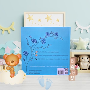 Peut inclure: Un livre pour enfants avec une couverture bleue et une illustration florale. Le texte comprend "Today everything is Blue - and tomorrow? Maybe Yellow!" et "Pour les bébés et les tout-petits de 0 à 3 ans."