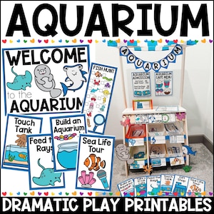 May include: A vibrant aquarium-themed play set with signs reading "Welcome to the Aquarium", "Touch Tank", and "Sea Life Tour". The set features a wooden stand with play elements and the word "AQUARIUM" in large letters.