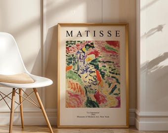May include: A framed art print featuring Henri Matisse's 1905 painting La Japonaise. The print displays a colorful, abstract figure in a kimono against a vibrant background, with the text MATISSE at the top and museum details at the bottom.