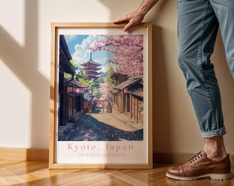 May include: A framed vertical art print featuring a vibrant illustration of a traditional Japanese street scene with a pagoda, cherry blossoms, and a red torii gate. The text at the bottom reads Kyoto, Japan followed by the coordinates 35°0'42"N 135°46'6"E.
