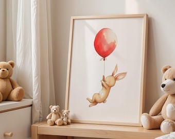 May include: A framed watercolor print featuring a light brown bunny holding onto a red balloon. The bunny is depicted mid-air, with the balloon floating above. The artwork is set in a light wood frame, suitable for a nursery or children's room.
