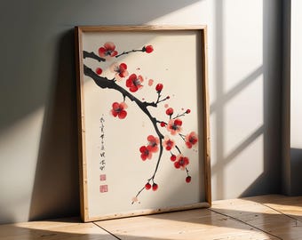 May include: A framed wall art print featuring a black ink branch with vibrant red plum blossoms on a cream background. The artwork includes vertical black calligraphy text and a small red square seal stamp in the lower left corner of the print.