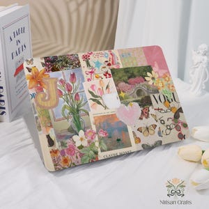 May include: A laptop case featuring a collage of floral and artistic images, including tulips, butterflies, and a heart-shaped embellishment. The design incorporates the letter "J" and the text "Vogue".
