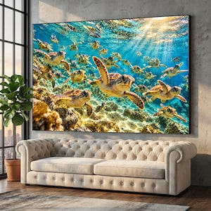May include: A large rectangular wall art print featuring a vibrant underwater scene with numerous sea turtles swimming near a rocky reef. Sunlight streams through the clear blue water from above, illuminating the turtles and the textured seabed.