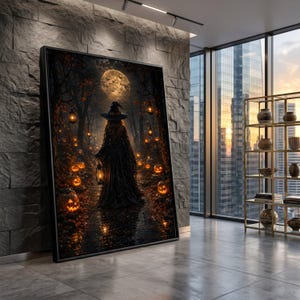 May include: A rectangular framed wall art print depicting a dark forest scene at night with a central figure wearing a wide-brimmed hat and cloak, holding a lantern, surrounded by glowing jack-o'-lanterns and hanging lanterns under a full moon.