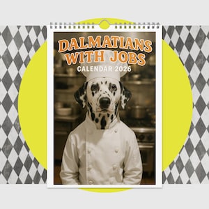 May include: A wall calendar featuring a Dalmatian dog dressed as a chef. The calendar cover reads "DALMATIANS WITH JOBS CALENDAR 2026" in orange text. The dog is wearing a white chef's coat and hat, with a kitchen background.