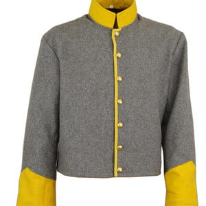 May include: A gray jacket with a yellow collar, trim, and cuffs. The jacket has gold-colored buttons down the front. The sleeves are long and the jacket is cropped at the waist. The jacket appears to be made of a wool-like material.