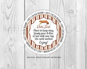 May include: A round, white sticker with brown and beige stripes. The sticker has text that reads "HOT COCOA BOMB" repeated around the edge. In the centre, there is a white circle with the text "Chai Tea" and instructions for making chai tea: "Place in large mug. Slowly pour 8-10oz of hot milk over top. Stir until melted. Enjoy!" The sticker also includes the text "DIGITAL PRINT READY ARTWORK".