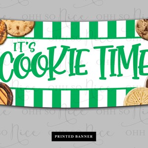 May include: A white and green striped banner with the text "It's Cookie Time" in green letters. The banner is decorated with various Girl Scout cookie images.