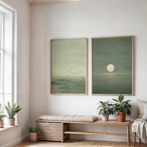 Minimalist Scandinavian wall art set of 2 showing a quiet ocean horizon in muted green tones and a glowing moon rising above the water